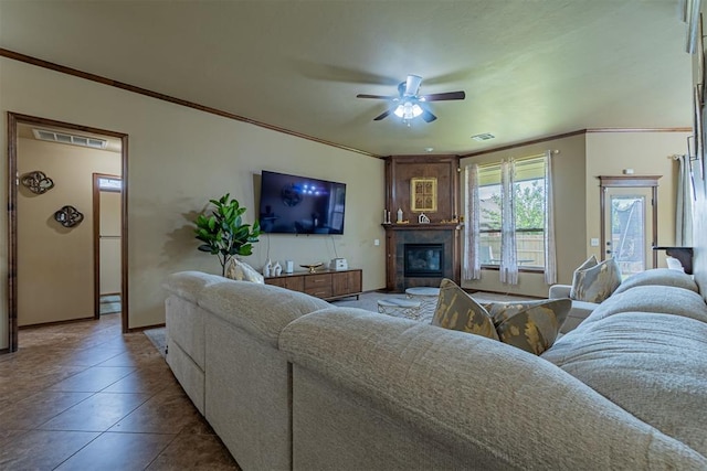 716 SW 157th St, Oklahoma City, OK 73170 - living room featuring ceiling fan, ornamental molding, and a tile fireplace