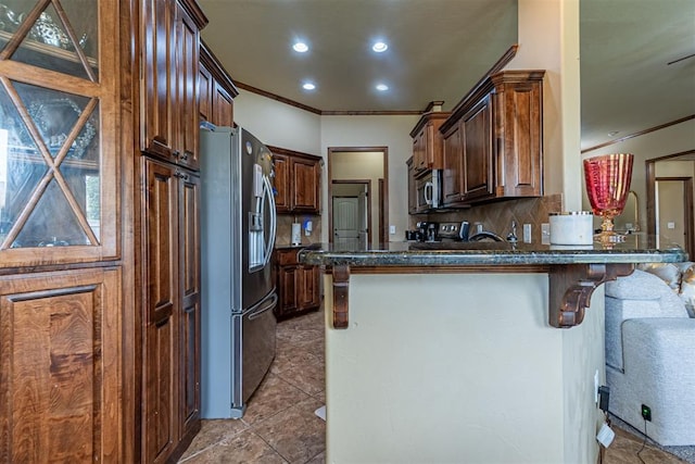 716 SW 157th St, Oklahoma City, OK 73170 - kitchen featuring appliances with stainless steel finishes, ornamental molding, a peninsula, decorative backsplash, and recessed lighting
