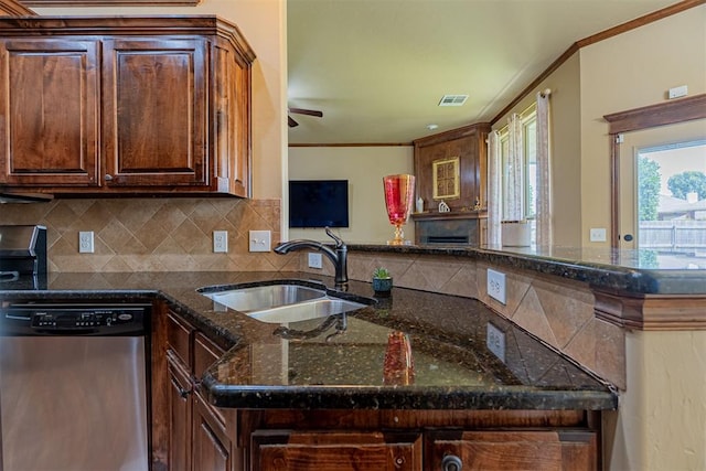 716 SW 157th St, Oklahoma City, OK 73170 - kitchen featuring stainless steel dishwasher, tasteful backsplash, dark stone countertops, ornamental molding, and ceiling fan