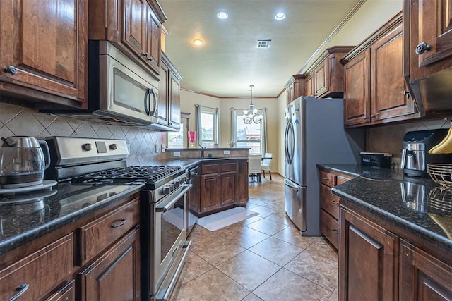 716 SW 157th St, Oklahoma City, OK 73170 - kitchen with appliances with stainless steel finishes, crown molding, decorative backsplash, recessed lighting, and pendant lighting