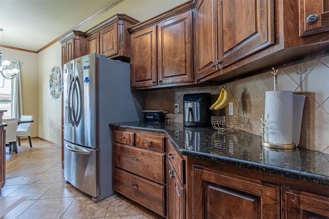 716 SW 157th St, Oklahoma City, OK 73170 - kitchen featuring stainless steel fridge with ice dispenser, crown molding, backsplash, a chandelier, and dark stone counters