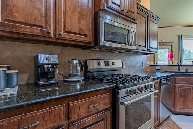 716 SW 157th St, Oklahoma City, OK 73170 - kitchen with appliances with stainless steel finishes, tasteful backsplash, and dark stone countertops