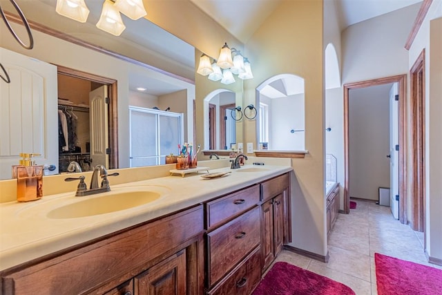 716 SW 157th St, Oklahoma City, OK 73170 - full bath featuring double vanity, a shower stall, tile patterned flooring, a spacious closet, and a bathtub