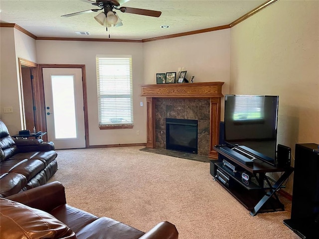 8905 Ava Ave, Oklahoma City, OK 73149 - living room featuring carpet flooring, a ceiling fan, ornamental molding, a tile fireplace, and a textured ceiling