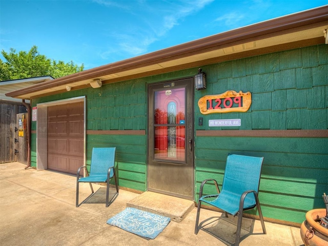1209 Dakota St, Norman, OK 73069 - property entrance with a garage and driveway