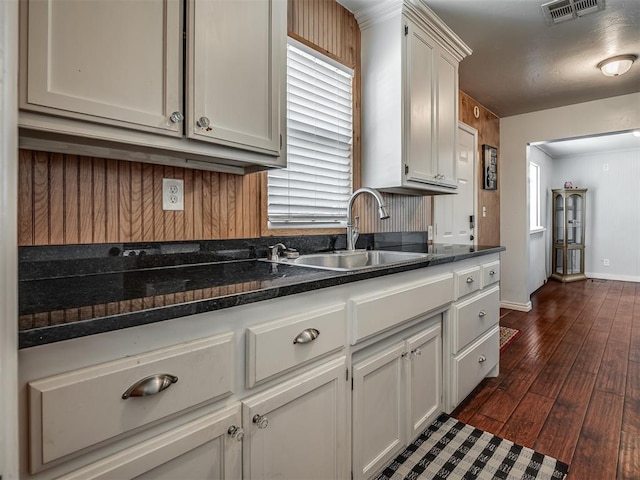 1209 Dakota St, Norman, OK 73069 - kitchen with dark wood-type flooring and white cabinets
