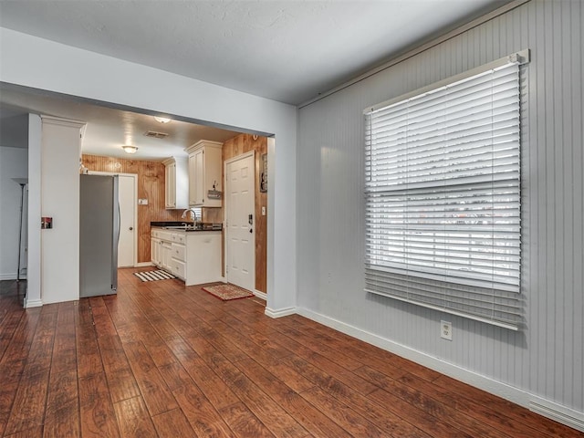 1209 Dakota St, Norman, OK 73069 - kitchen with freestanding refrigerator, dark countertops, and dark wood-style floors