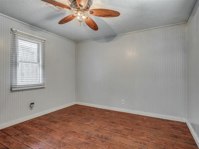 1209 Dakota St, Norman, OK 73069 - unfurnished room featuring hardwood / wood-style flooring, a textured ceiling, a ceiling fan, wooden walls, and crown molding