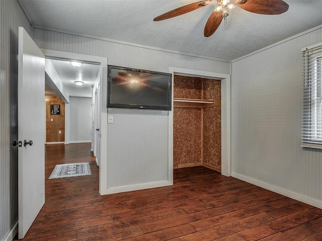 1209 Dakota St, Norman, OK 73069 - unfurnished bedroom featuring hardwood / wood-style floors, a closet, a textured ceiling, a ceiling fan, and wooden walls