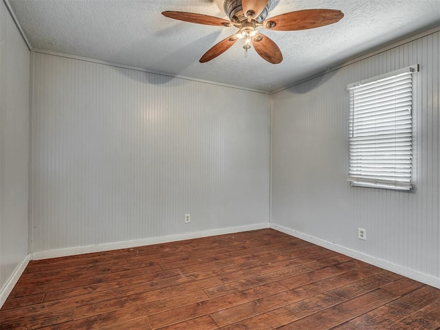 1209 Dakota St, Norman, OK 73069 - unfurnished room featuring a textured ceiling, hardwood / wood-style flooring, a ceiling fan, and wood walls