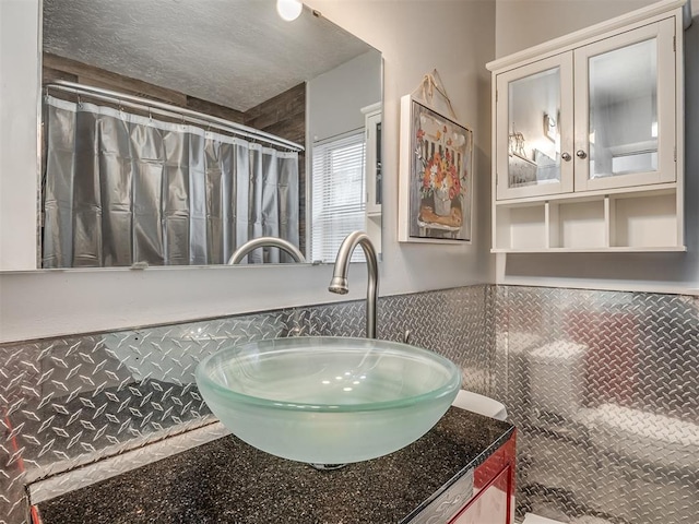 1209 Dakota St, Norman, OK 73069 - full bath featuring vanity, a wainscoted wall, curtained shower, and tile walls