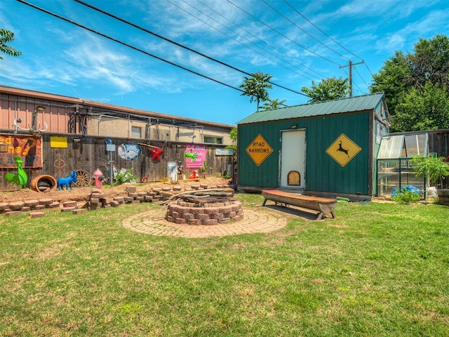 1209 Dakota St, Norman, OK 73069 - view of yard featuring a fire pit, an outbuilding, and an exterior structure