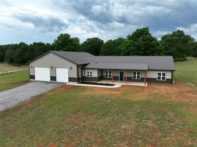17008 County St Unit 2750, Minco, OK 73059 - view of front of property with a front yard, a garage, driveway, and a metal roof