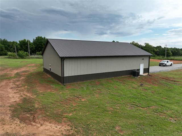 17008 County St Unit 2750, Minco, OK 73059 - view of home's exterior with a metal roof, an outbuilding, and a lawn