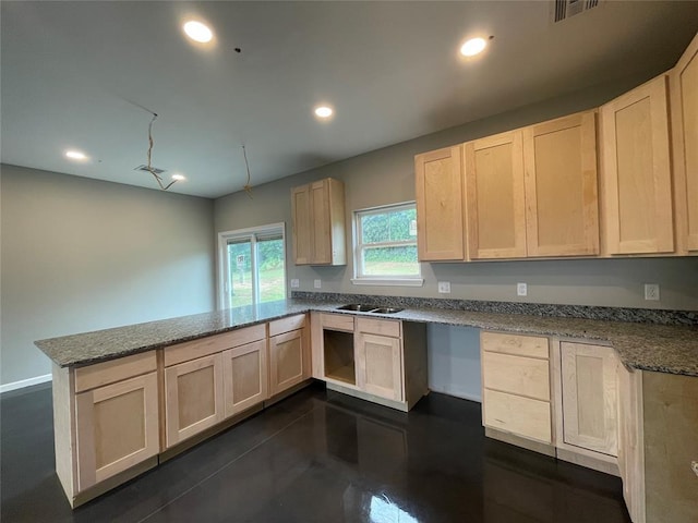 17008 County St Unit 2750, Minco, OK 73059 - kitchen with a peninsula, light brown cabinets, recessed lighting, dark stone countertops, and concrete floors