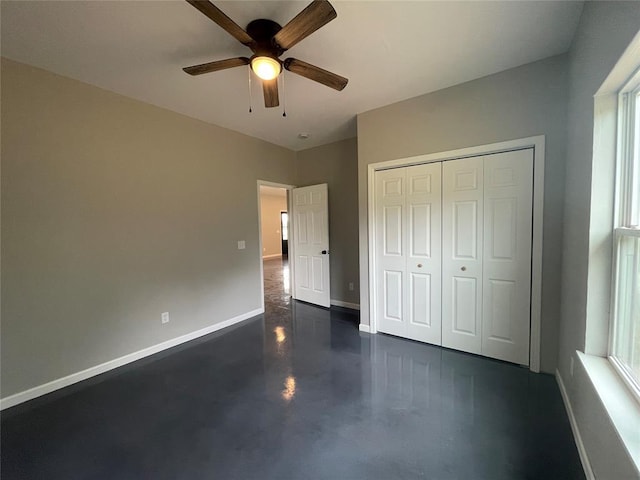 17008 County St Unit 2750, Minco, OK 73059 - unfurnished bedroom featuring concrete floors, a closet, multiple windows, and ceiling fan