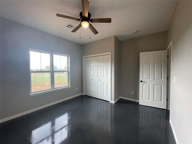 17008 County St Unit 2750, Minco, OK 73059 - unfurnished bedroom featuring a closet, a ceiling fan, and finished concrete floors