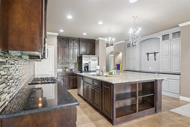 8401 NW 140th St, Oklahoma City, OK 73142 - kitchen featuring appliances with stainless steel finishes, open shelves, ornamental molding, dark brown cabinets, and backsplash