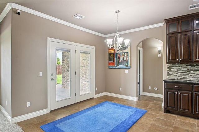 8401 NW 140th St, Oklahoma City, OK 73142 - doorway with arched walkways, crown molding, light tile patterned floors, and french doors