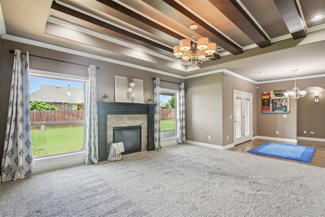 8401 NW 140th St, Oklahoma City, OK 73142 - unfurnished living room with a chandelier, a stone fireplace, ornamental molding, and carpet flooring