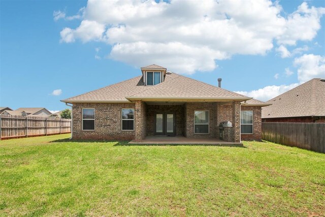 8401 NW 140th St, Oklahoma City, OK 73142 - back of house featuring a fenced backyard, brick siding, a patio area, and a shingled roof