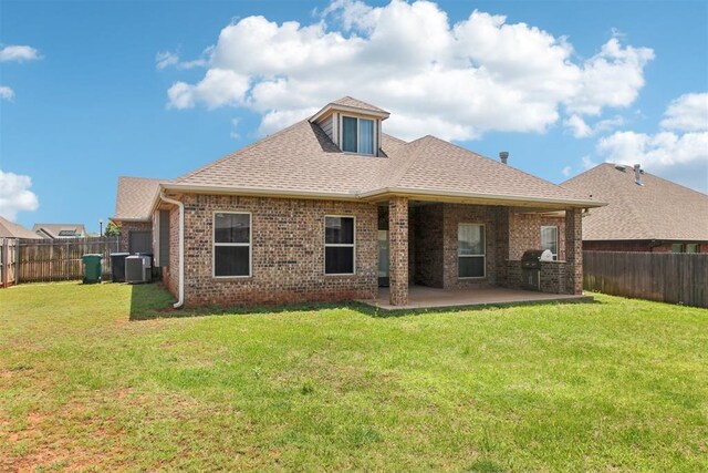 8401 NW 140th St, Oklahoma City, OK 73142 - back of property with a fenced backyard, brick siding, a patio, and roof with shingles