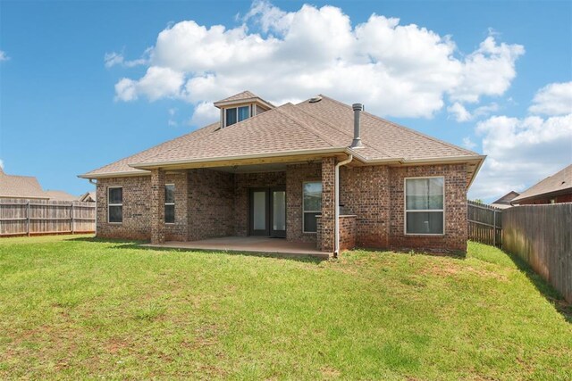 8401 NW 140th St, Oklahoma City, OK 73142 - back of house with a fenced backyard, a patio area, brick siding, and roof with shingles