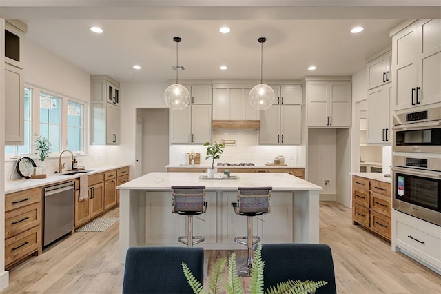 1801 Cedar Valley Mnr, Guthrie, OK 73044 - kitchen with appliances with stainless steel finishes, decorative backsplash, light wood-style flooring, light stone countertops, and recessed lighting
