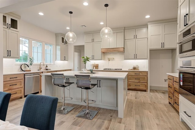 1801 Cedar Valley Mnr, Guthrie, OK 73044 - kitchen with appliances with stainless steel finishes, a center island, decorative backsplash, glass insert cabinets, and recessed lighting