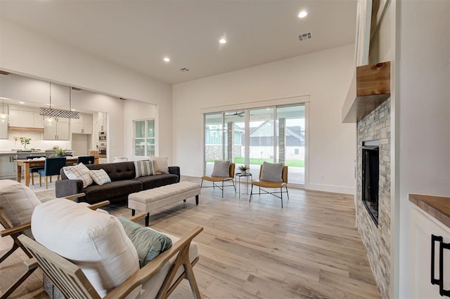 1801 Cedar Valley Mnr, Guthrie, OK 73044 - living room featuring light wood-style flooring, recessed lighting, and a fireplace