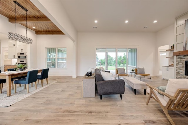 1801 Cedar Valley Mnr, Guthrie, OK 73044 - living room featuring light wood finished floors, a wood ceiling with exposed beams, recessed lighting, and a stone fireplace