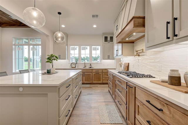 1801 Cedar Valley Mnr, Guthrie, OK 73044 - kitchen featuring stainless steel gas cooktop, recessed lighting, decorative backsplash, light wood-type flooring, and a center island
