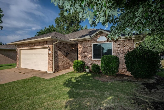 912 S Boynton Ave, El Reno, OK 73036 - single story home featuring a garage, a front yard, driveway, and brick siding