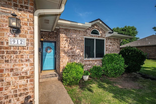 912 S Boynton Ave, El Reno, OK 73036 - property entrance featuring brick siding and a yard