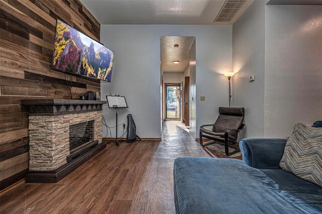 912 S Boynton Ave, El Reno, OK 73036 - living room featuring wood finished floors and a stone fireplace