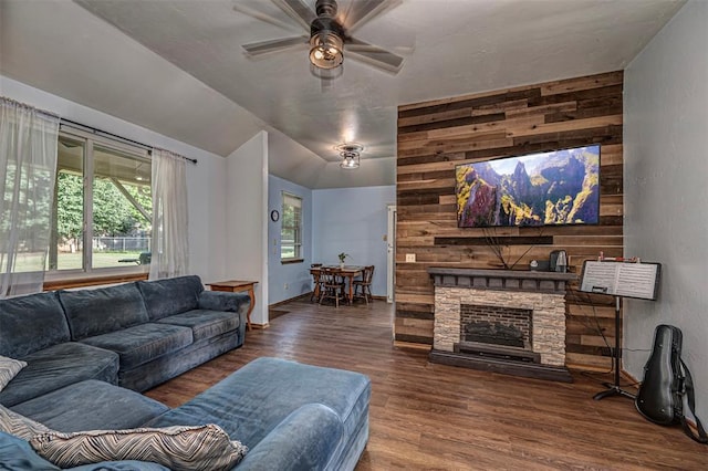 912 S Boynton Ave, El Reno, OK 73036 - living room with a ceiling fan, wood finished floors, a fireplace, and wooden walls