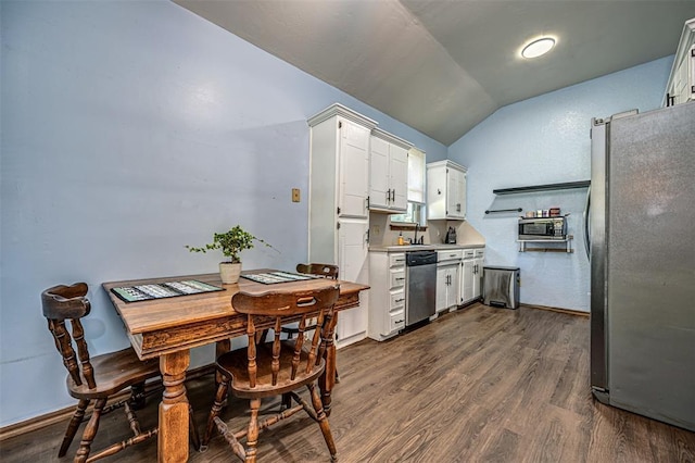 912 S Boynton Ave, El Reno, OK 73036 - kitchen with stainless steel appliances, lofted ceiling, light countertops, white cabinets, and dark wood-type flooring