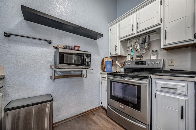 912 S Boynton Ave, El Reno, OK 73036 - kitchen featuring stainless steel appliances, dark wood-style flooring, and white cabinets