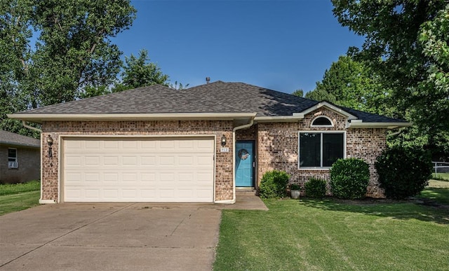912 S Boynton Ave, El Reno, OK 73036 - single story home featuring concrete driveway, a front lawn, brick siding, and a garage