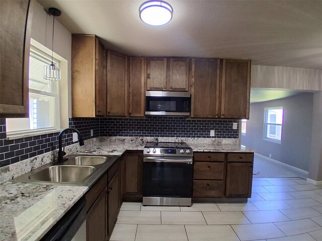 814 E Midland St, Shawnee, OK 74804 - kitchen featuring appliances with stainless steel finishes, tasteful backsplash, decorative light fixtures, and light tile patterned floors