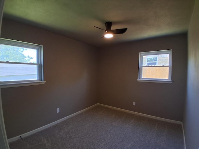 814 E Midland St, Shawnee, OK 74804 - spare room featuring a ceiling fan and dark colored carpet