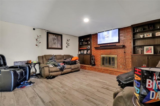 4904 Washington St, Oklahoma City, OK 73135 - living area featuring wood finished floors, a brick fireplace, and built in features