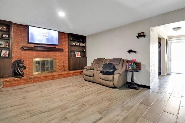 4904 Washington St, Oklahoma City, OK 73135 - living area with wood finished floors, built in features, and a brick fireplace