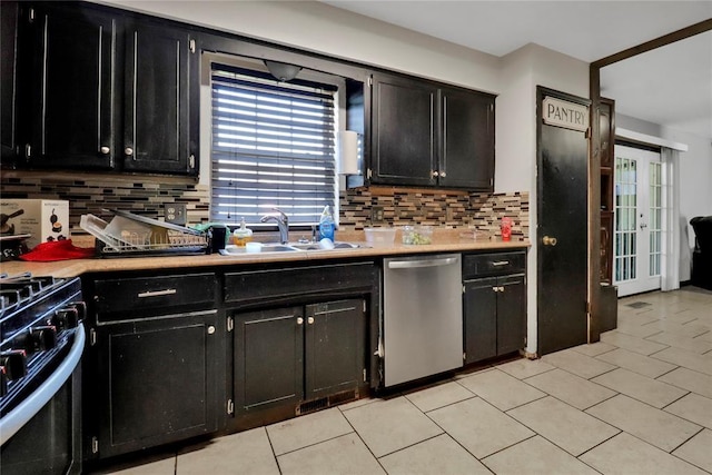 4904 Washington St, Oklahoma City, OK 73135 - kitchen featuring stainless steel dishwasher, range with gas stovetop, dark cabinets, and healthy amount of natural light