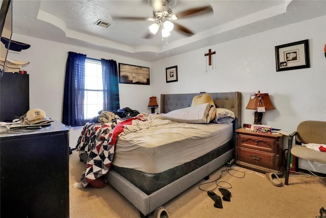 4904 Washington St, Oklahoma City, OK 73135 - bedroom with a tray ceiling, light carpet, and ceiling fan