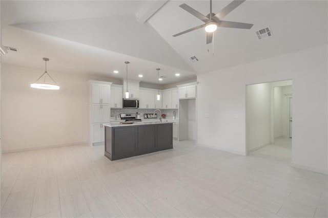 316 SE 45th St, Oklahoma City, OK 73129 - kitchen with stainless steel appliances, light countertops, ceiling fan, white cabinets, and tasteful backsplash