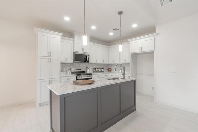 316 SE 45th St, Oklahoma City, OK 73129 - kitchen featuring stainless steel appliances, white cabinets, decorative backsplash, and recessed lighting