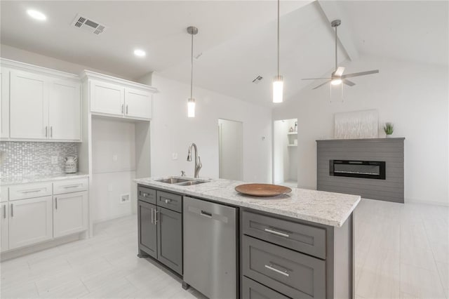 316 SE 45th St, Oklahoma City, OK 73129 - kitchen featuring stainless steel dishwasher, white cabinets, tasteful backsplash, open floor plan, and light stone counters