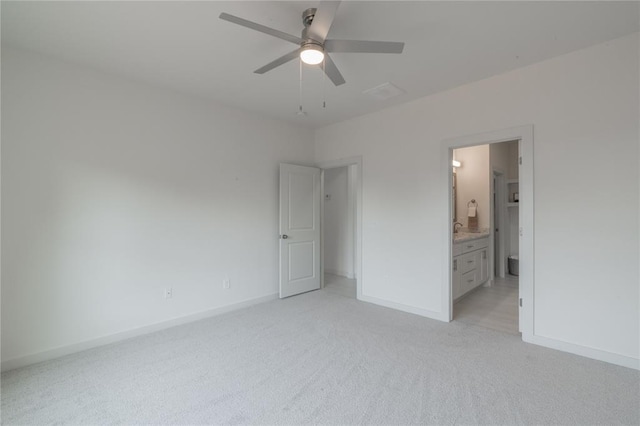 316 SE 45th St, Oklahoma City, OK 73129 - unfurnished bedroom featuring light carpet, connected bathroom, and a ceiling fan