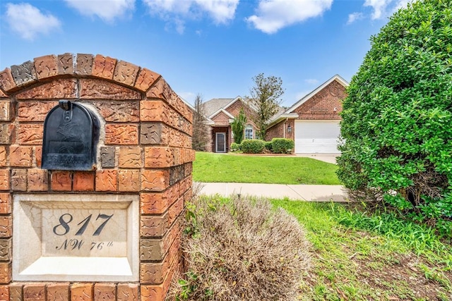 817 NW 76th St, Lawton, OK 73505 - view of front of house with a front lawn, brick siding, and a garage